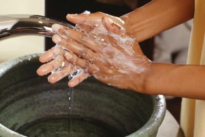 african washing hands with soap