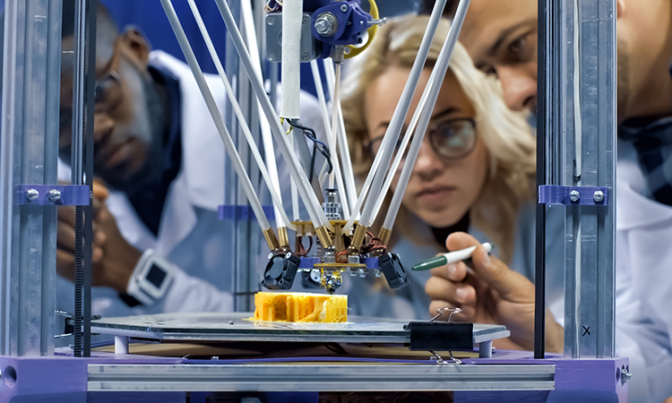 scientists around a 3-d printer