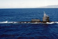 A photograph of the USS William H. Bates (SSN-680) submerged in the ocean with light filtering down from the surface. The author, Darin Detwiler, served on this submarine.