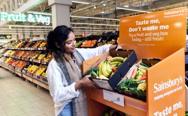 Sainsbury's customer holding 'Taste Me, Don't Waste Me' boxes will include a variety of surplus fresh fruit and vegetables sold at a lower price than usual as the cost of living crisis continues to rise