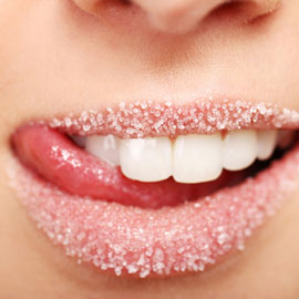 Woman licking sugar off lips