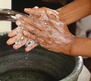 african washing hands with soap