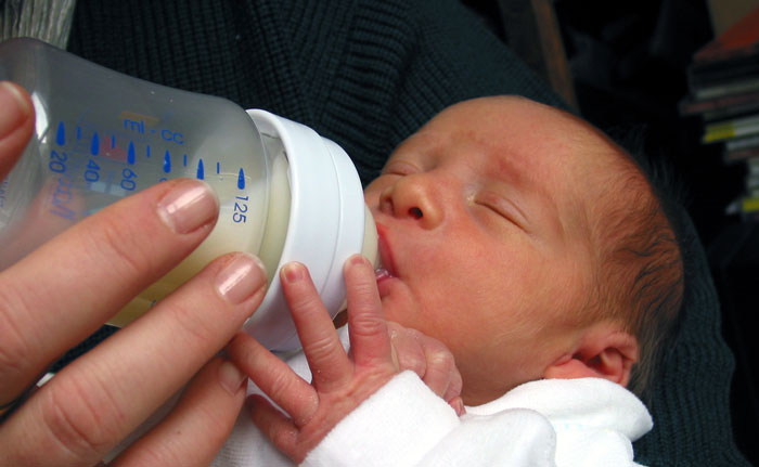 preterm baby drinking human milk-based formula