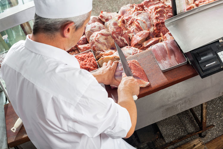 butcher slicing meat
