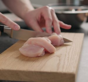 consumer cutting chicken