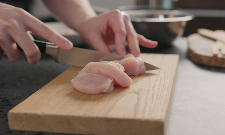 consumer cutting chicken