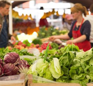 people buying vegetables at market