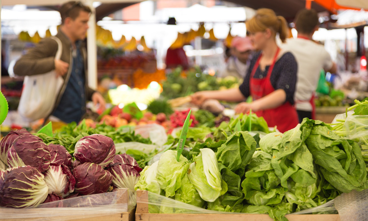 people buying vegetables at market