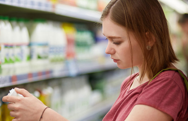 Girl checking milk