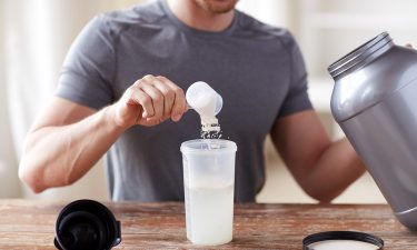 ,man pours protein powder