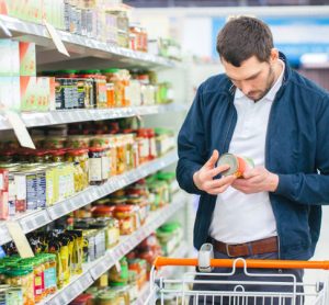 Man browsing food label in supermarket