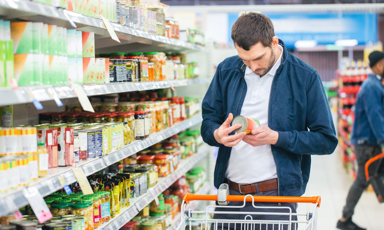 Man browsing food label in supermarket