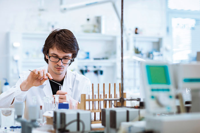 man in lab testing oil