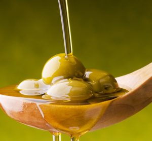 Olive oil poured on spoon