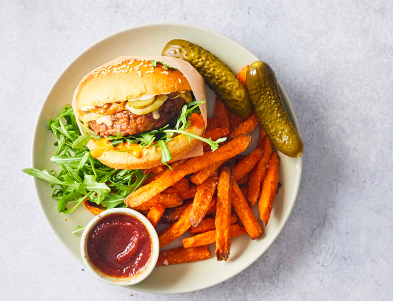 Plant-based burger and chips on a plate