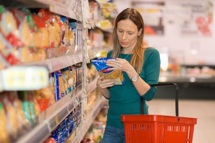 woman reading food label