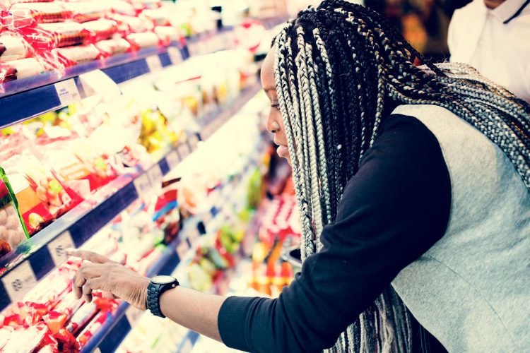 Lady looking at food in supermarket