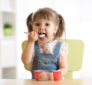 child eating yoghurt