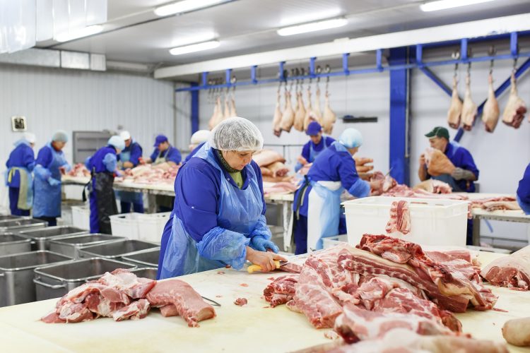 woman cutting pork