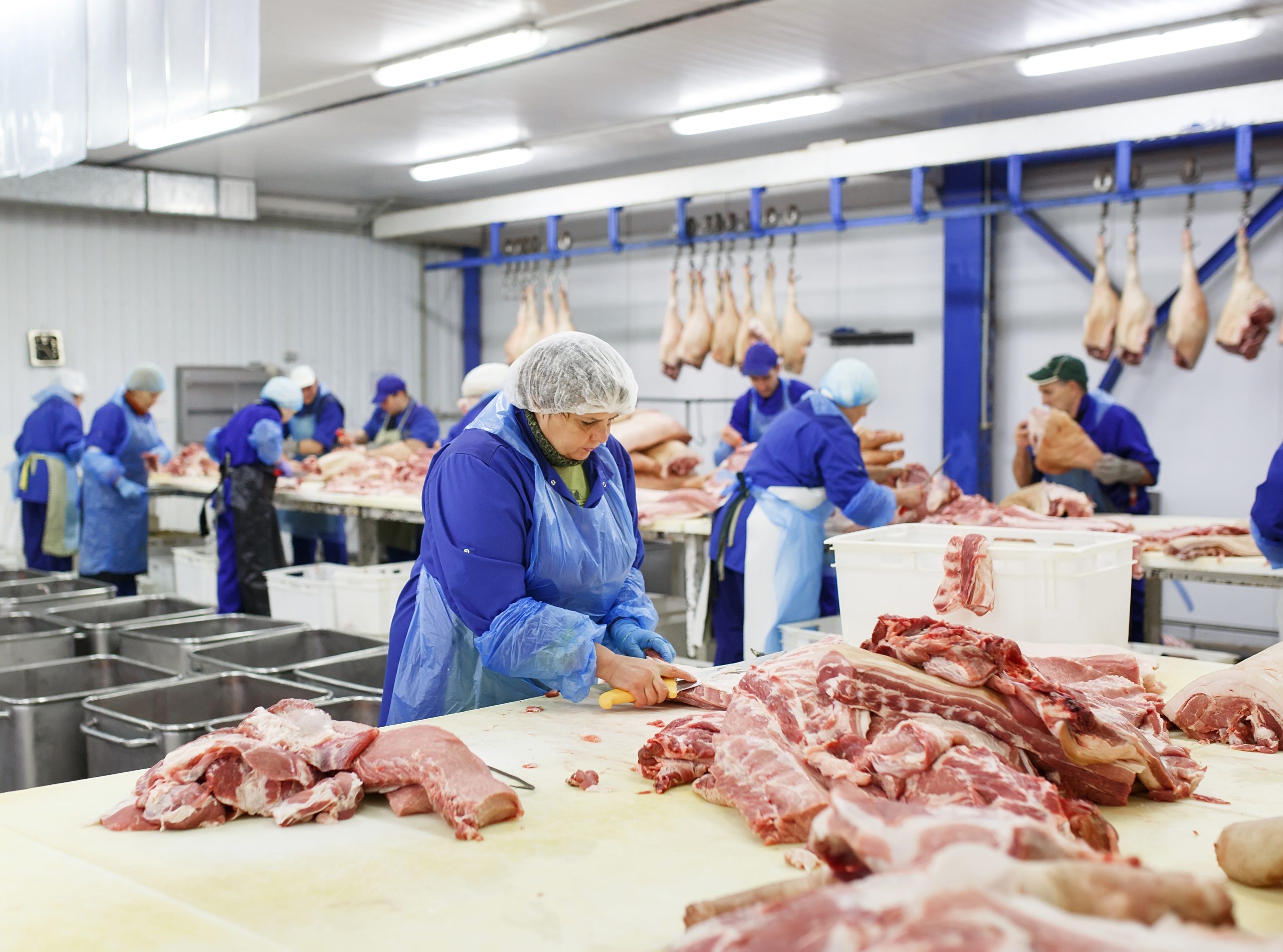 woman cutting pork