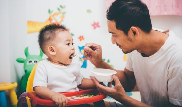 father feeding his baby