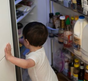 child looking in fridge