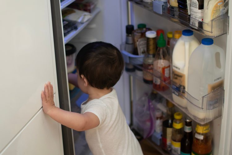 child looking in fridge