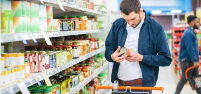 man holding canned food