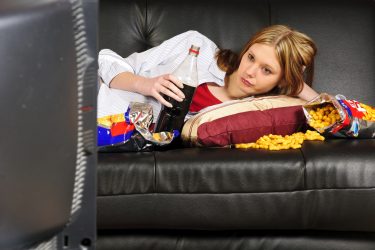Eating junk food on sofa