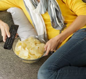 eating crisps on sofa