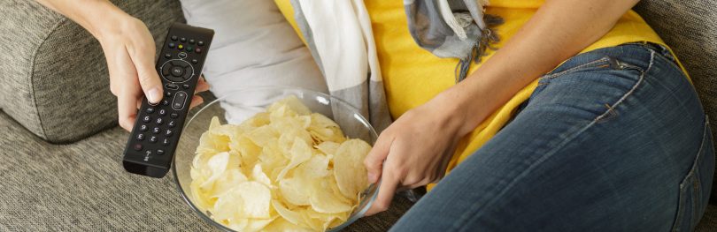 eating crisps on sofa