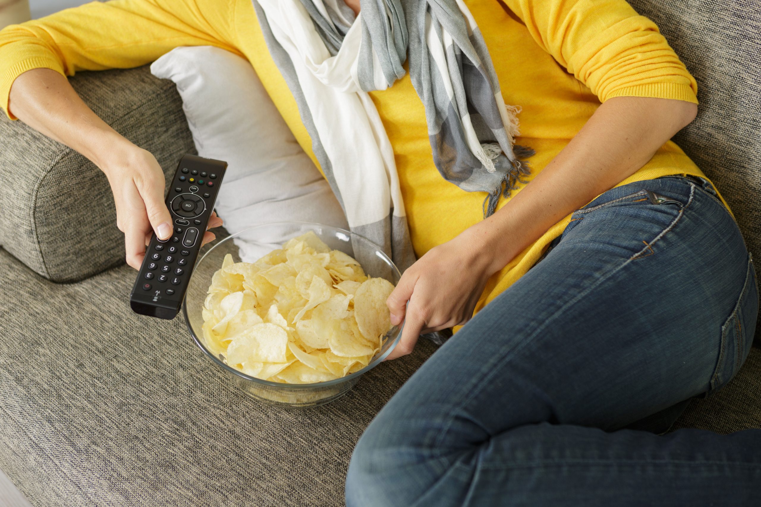 eating crisps on sofa