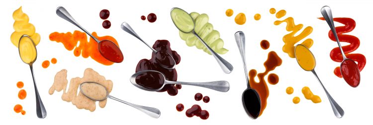 salad dressings on spoons