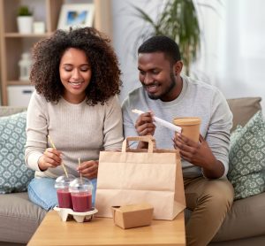 man and woman with takeaway bag