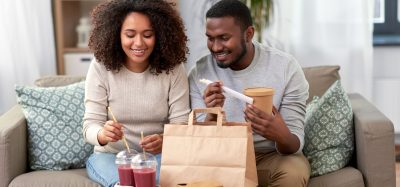 man and woman with takeaway bag
