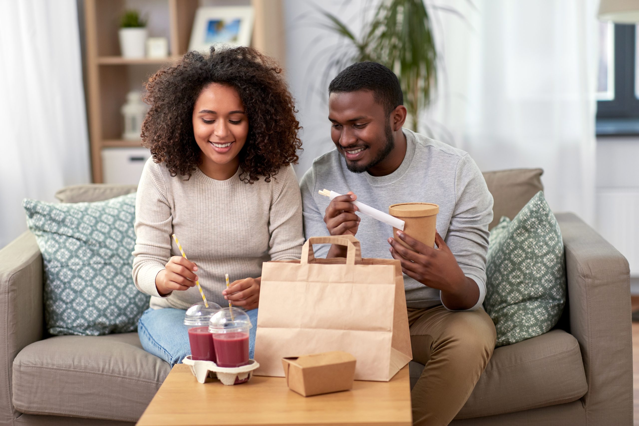 man and woman with takeaway bag