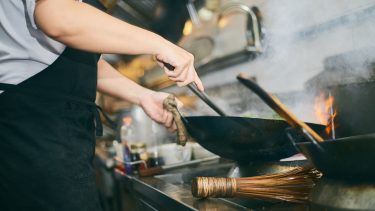 Chef cooking with wok