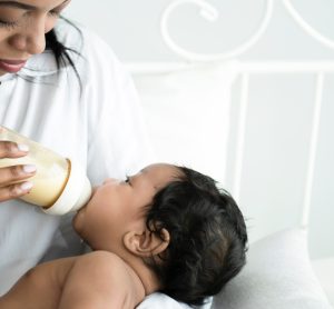 mother feeding baby formula