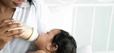 mother feeding baby formula