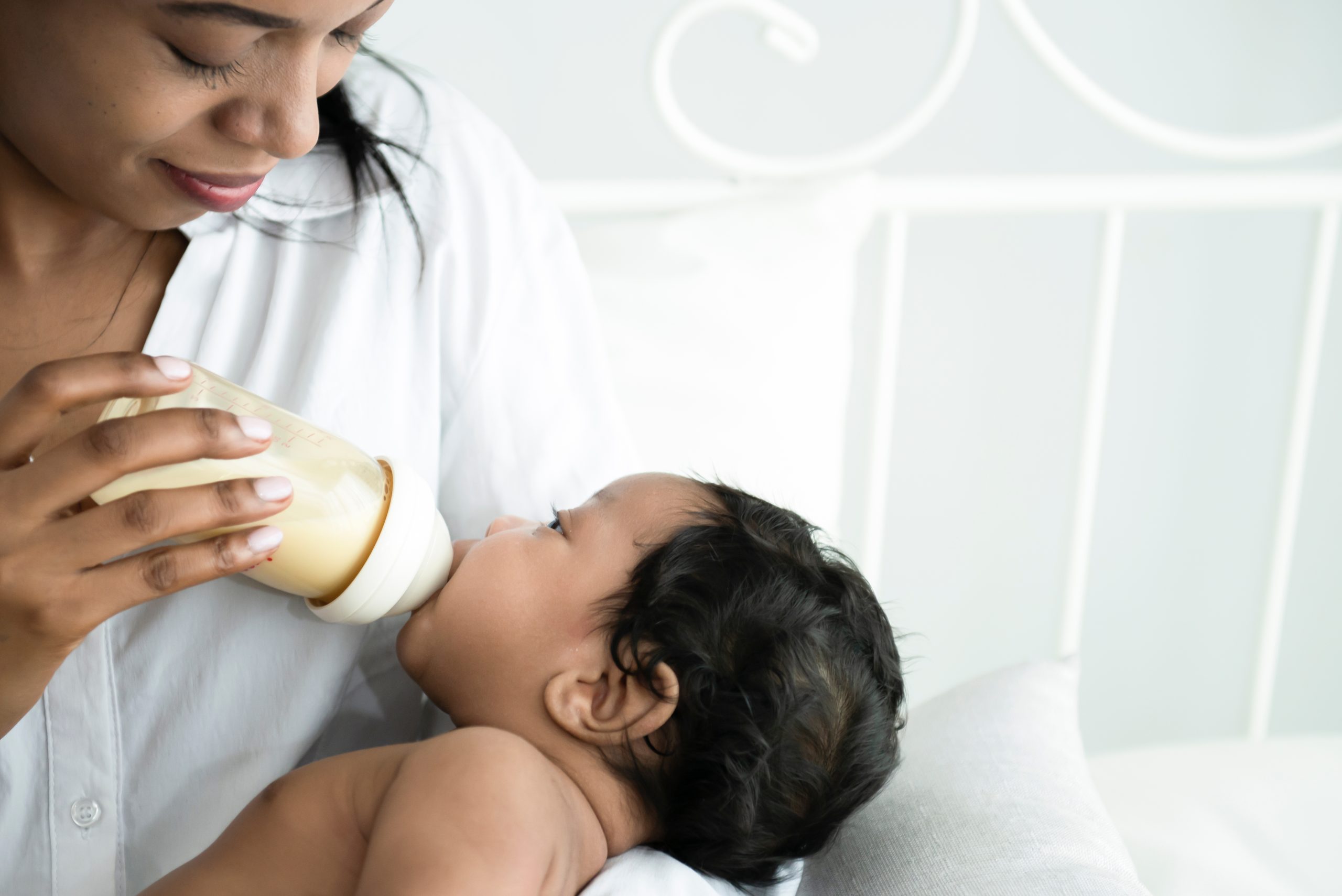 mother feeding baby formula