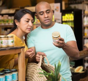 couple looking at jar label