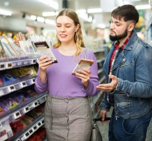 couple buying chocolate in shop