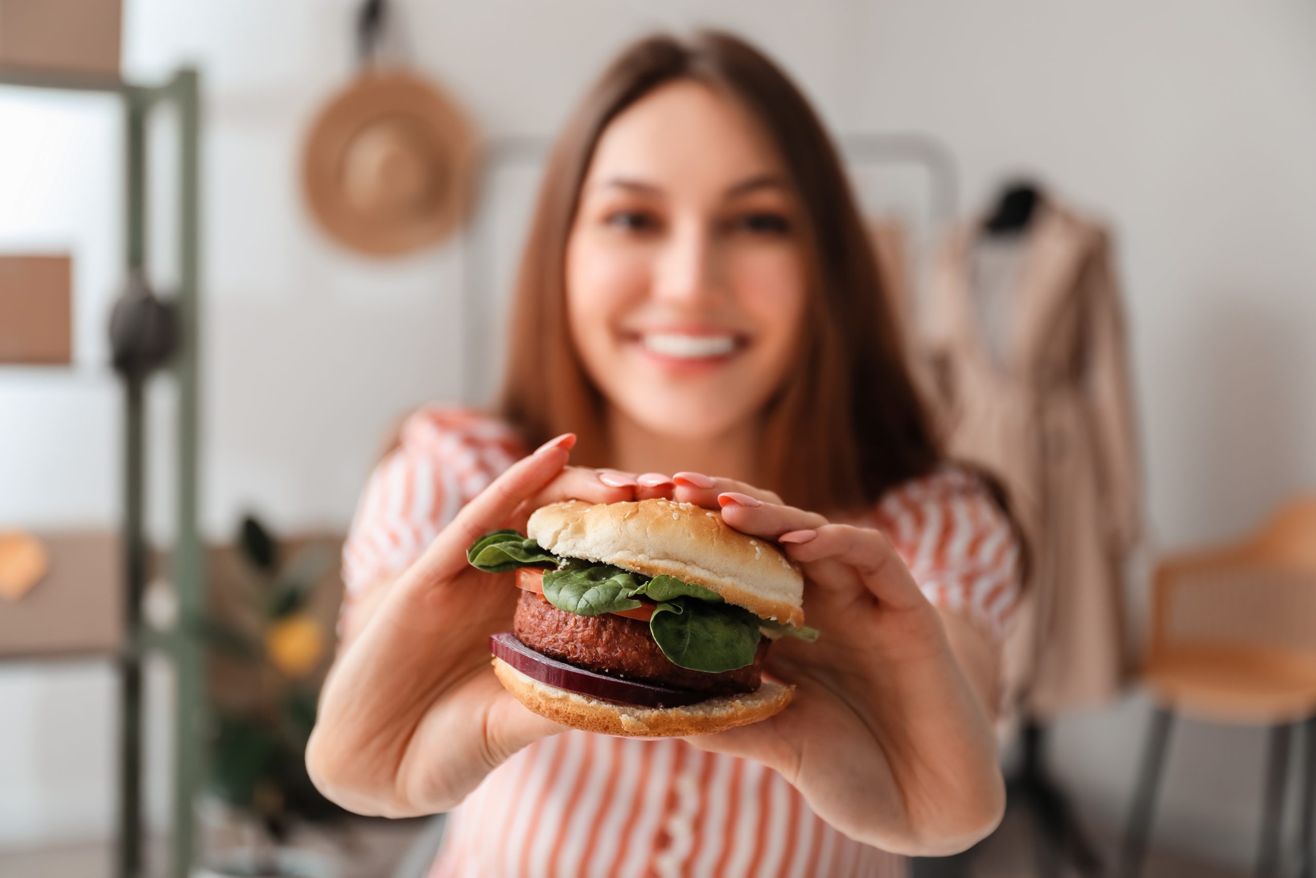 woman holding plant-based burger
