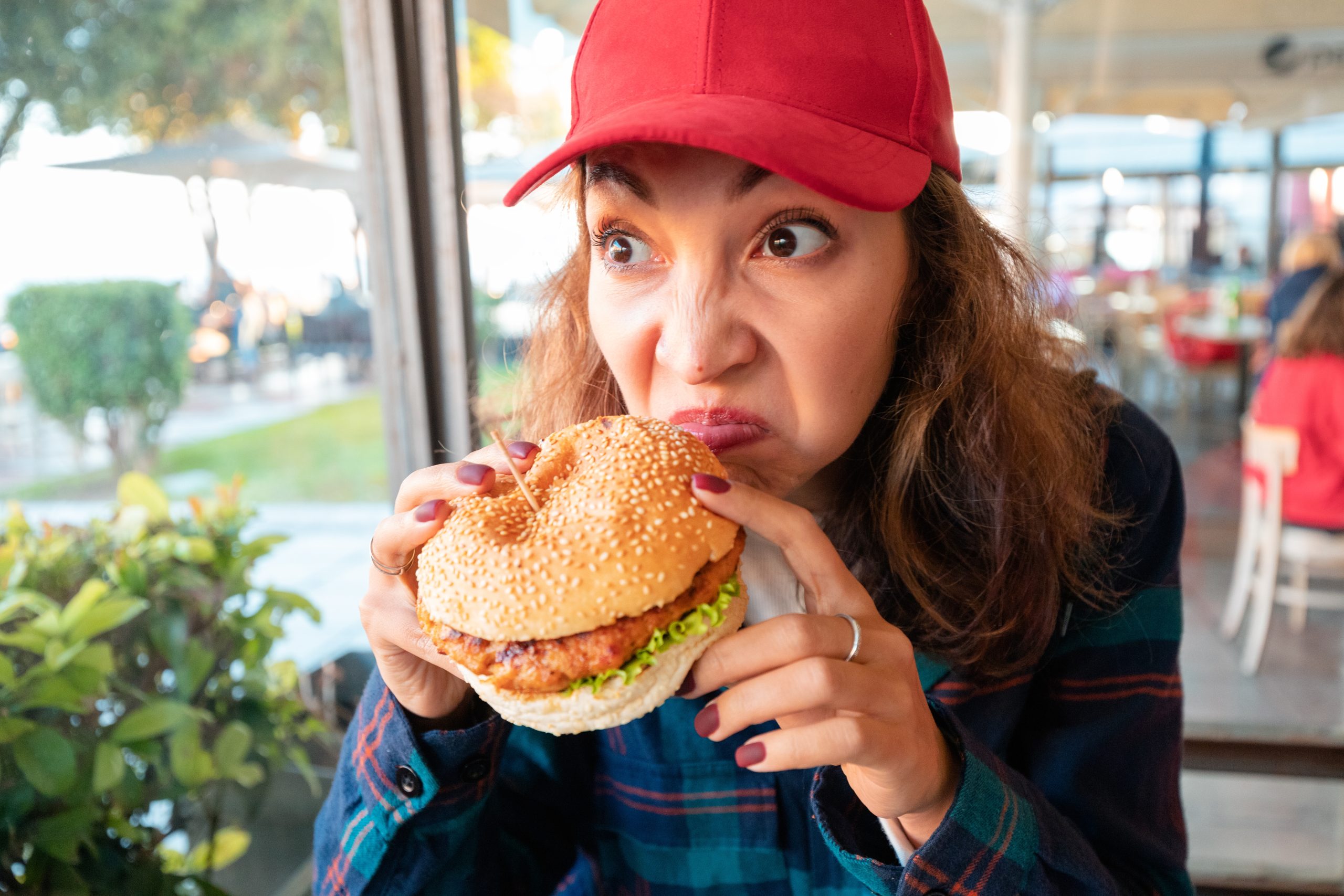 woman sniffing burger