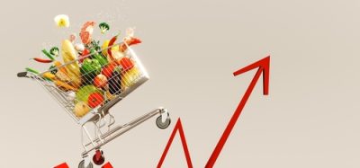 British food price inflation 2025 depicted. An image depicting a shopping cart full of groceries, on the back of an inflation line graph, progressing upwards to depict food costs rising.