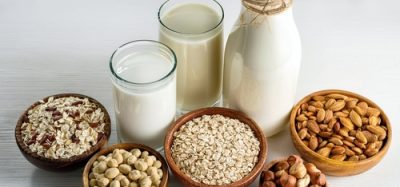 An assortment of alternative protein derived milks, including almond milk, soya milk and pea milk.