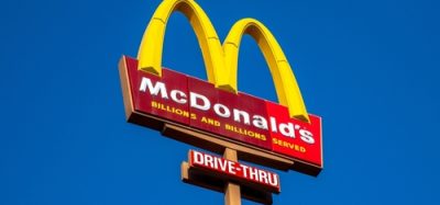 A McDonald's sign set against the backdrop of blue sky