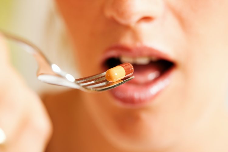 Woman eating pill