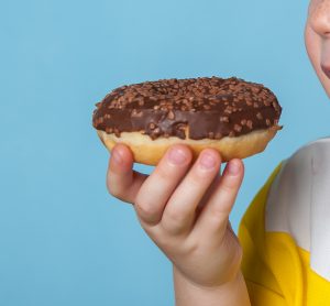 child eating doughnut