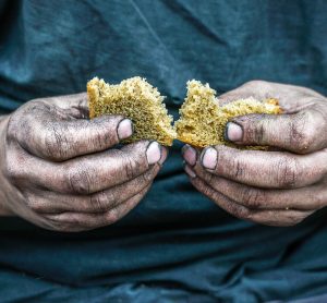 dirty hands holding bread